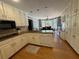 Kitchen with white cabinets, stainless steel appliances, granite countertops and hardwood floors at 1153 Staples Sw Dr, Lilburn, GA 30047