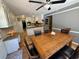 Cozy kitchen with modern lighting, granite countertops, stainless appliances, and adjacent dining area at 1153 Staples Sw Dr, Lilburn, GA 30047