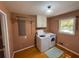 Functional laundry room with washer, dryer, and shelving at 1153 Staples Sw Dr, Lilburn, GA 30047
