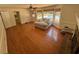 Open living room with hardwood floors, large windows overlooking a pool, and a comfortable seating area at 1153 Staples Sw Dr, Lilburn, GA 30047
