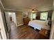 Spacious bedroom with a ceiling fan, wood flooring, and two windows providing natural light at 1153 Staples Sw Dr, Lilburn, GA 30047