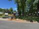 Traditional home with well-manicured lawn, mature trees, and long driveway at 1153 Staples Sw Dr, Lilburn, GA 30047
