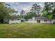Expansive backyard with a well-maintained lawn, showcasing the house and additional outbuilding at 317 Community Sw Dr, Mableton, GA 30126