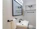 This is a modern bathroom featuring sleek fixtures, minimalist design, and ample lighting at 317 Community Sw Dr, Mableton, GA 30126