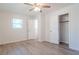 Bright bedroom featuring wood floors, closet and ceiling fan at 317 Community Sw Dr, Mableton, GA 30126