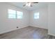 This is a simple bedroom with wood floors, natural light, and a ceiling fan at 317 Community Sw Dr, Mableton, GA 30126