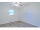 This is a simple bedroom with wood floors, natural light, and a ceiling fan at 317 Community Sw Dr, Mableton, GA 30126