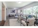 Spacious living room with modern furniture, neutral tones, and a large window at 317 Community Sw Dr, Mableton, GA 30126