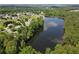 Beautiful aerial view of a serene lake surrounded by lush green trees and residential homes, reflecting a peaceful neighborhood at 330 Bay Grove Rd, Loganville, GA 30052