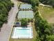 A stunning aerial view shows well-maintained tennis courts, swimming pool and parking in a beautiful residential community at 330 Bay Grove Rd, Loganville, GA 30052