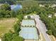 Aerial view of community tennis courts, pool, parking, and lake surrounded by lush greenery at 330 Bay Grove Rd, Loganville, GA 30052