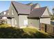 Exterior view showcases the home's light green siding, fenced yard, and mature landscaping at 330 Bay Grove Rd, Loganville, GA 30052