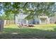 Large, fenced backyard featuring a stone firepit, patio, grill and lawn at 330 Bay Grove Rd, Loganville, GA 30052