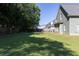 The backyard of the green home features a spacious lawn and a charming patio set for outdoor enjoyment at 330 Bay Grove Rd, Loganville, GA 30052
