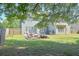 Large, fenced backyard featuring a stone firepit, patio and lawn at 330 Bay Grove Rd, Loganville, GA 30052