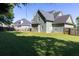 A spacious, grassy backyard of a green home offers plenty of room for recreation and outdoor activities at 330 Bay Grove Rd, Loganville, GA 30052