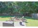 A backyard featuring a stone firepit with seating at 330 Bay Grove Rd, Loganville, GA 30052