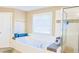 Bathroom featuring a large tub, a shower, and a window at 330 Bay Grove Rd, Loganville, GA 30052