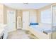 Bright bathroom featuring a large tub, vanity, and tile flooring at 330 Bay Grove Rd, Loganville, GA 30052