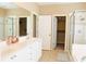 Bathroom featuring double vanity, tiled walk-in shower, and soaking tub at 330 Bay Grove Rd, Loganville, GA 30052