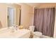 Well-lit bathroom featuring a shower and tub combo, toilet, and sink with ample countertop space at 330 Bay Grove Rd, Loganville, GA 30052