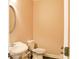 Small, but clean powder room with white fixtures, including a toilet and pedestal sink at 330 Bay Grove Rd, Loganville, GA 30052