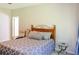 Comfortable bedroom with a wooden bed frame, soft lighting, and neutral decor at 330 Bay Grove Rd, Loganville, GA 30052