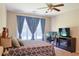 Bedroom featuring light walls, 3 windows with light blue curtains, fireplace, and desk area at 330 Bay Grove Rd, Loganville, GA 30052