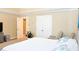 Bedroom with tray ceiling, neutral tones, and ensuite bathroom and closet at 330 Bay Grove Rd, Loganville, GA 30052
