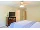 Bright bedroom featuring a ceiling fan, dresser, and comfortable bed, creating a cozy retreat at 330 Bay Grove Rd, Loganville, GA 30052