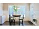 Sunlit breakfast nook with a round table, white wainscoting and large windows at 330 Bay Grove Rd, Loganville, GA 30052
