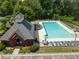 Community pool featuring lounge chairs, umbrellas, and a tennis court in the background at 330 Bay Grove Rd, Loganville, GA 30052