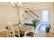 Open dining room with a view to the staircase with a white banister and dark wood floors at 330 Bay Grove Rd, Loganville, GA 30052