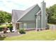 The side of this home shows a chimney, well manicured lawn and attractive landscaping at 330 Bay Grove Rd, Loganville, GA 30052
