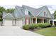 Charming home featuring a three-car garage, beautifully landscaped yard, and inviting covered porch at 330 Bay Grove Rd, Loganville, GA 30052