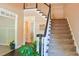 Welcoming foyer featuring a staircase with dark wood accents and a glimpse into a living area at 330 Bay Grove Rd, Loganville, GA 30052