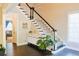 Open foyer with a staircase, dark wood floors, and a view into the living area at 330 Bay Grove Rd, Loganville, GA 30052