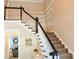Elegant foyer featuring a staircase with a black and white railing, and neutral wall colors at 330 Bay Grove Rd, Loganville, GA 30052