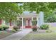 Charming front entrance featuring a red double door, decorative bushes, and a well-manicured lawn at 330 Bay Grove Rd, Loganville, GA 30052