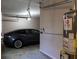 A two-car garage offers parking for cars and additional storage space next to a water heater at 330 Bay Grove Rd, Loganville, GA 30052