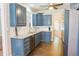 Well-lit kitchen features blue cabinets, stainless steel appliances and granite countertops at 330 Bay Grove Rd, Loganville, GA 30052