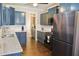 The renovated kitchen offers blue cabinets, granite countertops and stainless steel appliances at 330 Bay Grove Rd, Loganville, GA 30052