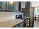 Modern kitchen features gray cabinets, granite countertops and stainless steel appliances at 330 Bay Grove Rd, Loganville, GA 30052