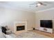 Living room featuring fireplace, ceiling fan, tv, and sectional couch at 330 Bay Grove Rd, Loganville, GA 30052
