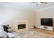 Living room featuring fireplace, ceiling fan, tv, and sectional couch at 330 Bay Grove Rd, Loganville, GA 30052