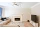 Cozy living room featuring a fireplace, plush seating, ceiling fan, and neutral tones at 330 Bay Grove Rd, Loganville, GA 30052