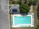 Aerial shot of the pool and pool house along with a parking lot and some landscaping, perfect for community gatherings at 330 Bay Grove Rd, Loganville, GA 30052