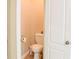 Powder room includes toilet, toilet paper holder, and door at 330 Bay Grove Rd, Loganville, GA 30052