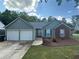 Charming single Gathering home with light blue siding, brick accents, two-car garage and manicured lawn at 4811 Lake Park Ter, Acworth, GA 30101