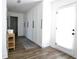 Hallway with plank flooring, storage cabinets, area rug, and access to the exterior at 4811 Lake Park Ter, Acworth, GA 30101